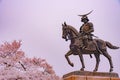 A statue of Masamune Date on horseback entering Sendai Castle in full bloom cherry blossom, Aobayama Park, Sendai, Miyagi, Japan Royalty Free Stock Photo